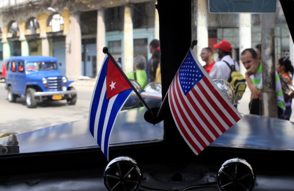 Miniature flags representing Cuba and the U.S. are displayed on the dash of an American classic car in Havana, Cuba, March 22, 2013. U.S. 