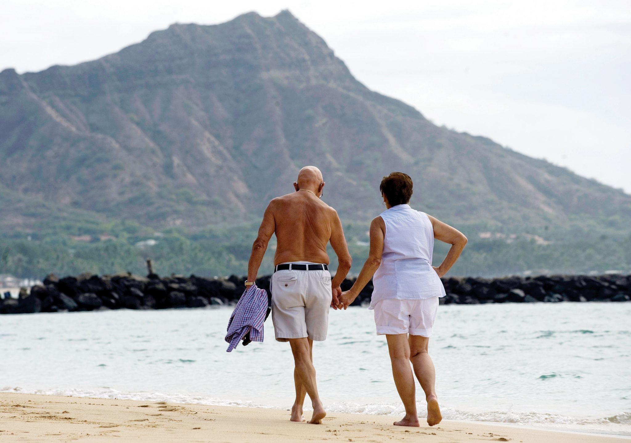 A quiet walk under the backdrop of Diamond Head is part of the experience of visiting Duke Kahanamoku Beach in Hawaii. 