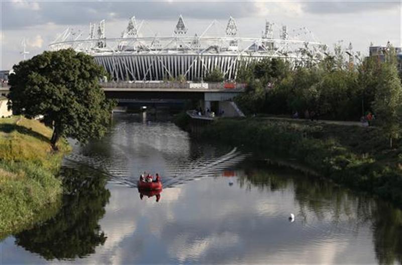 A rescue boat travels upriver by the Olympic Stadium in the Olympic Park in London. 