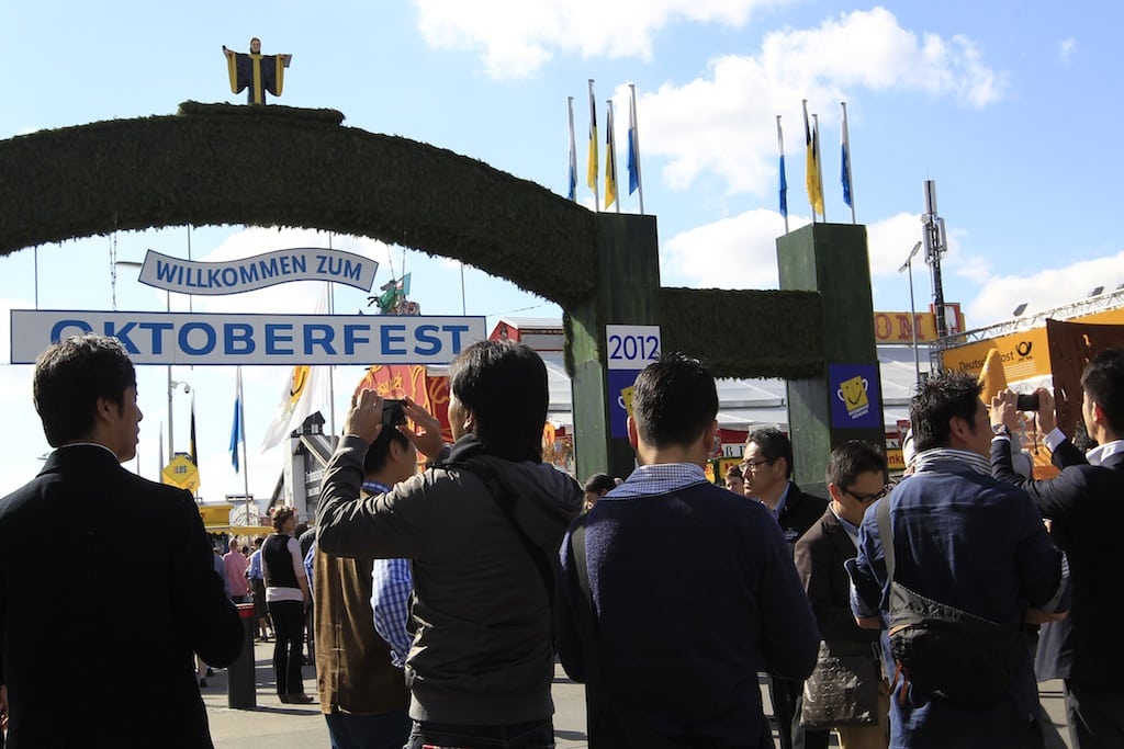 Chinese tourists take pictures of the Oktoberfest entrance during their visit of the famous Oktoberfest in Munich September 28, 2012. 