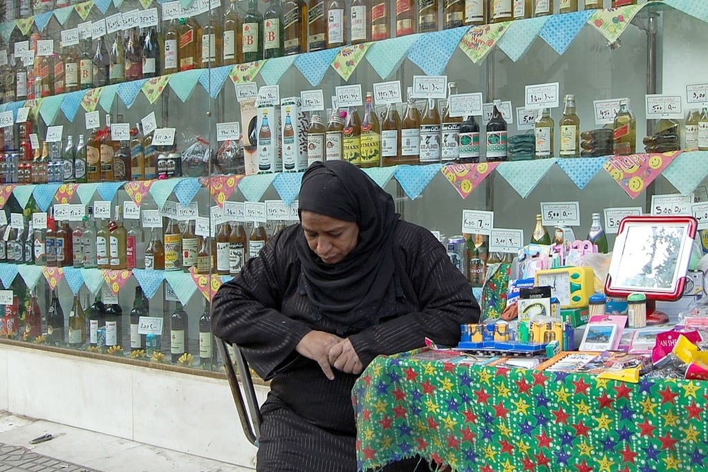 A vendor sits in an alcohol shop in Cairo, Egypt in 2007. 
