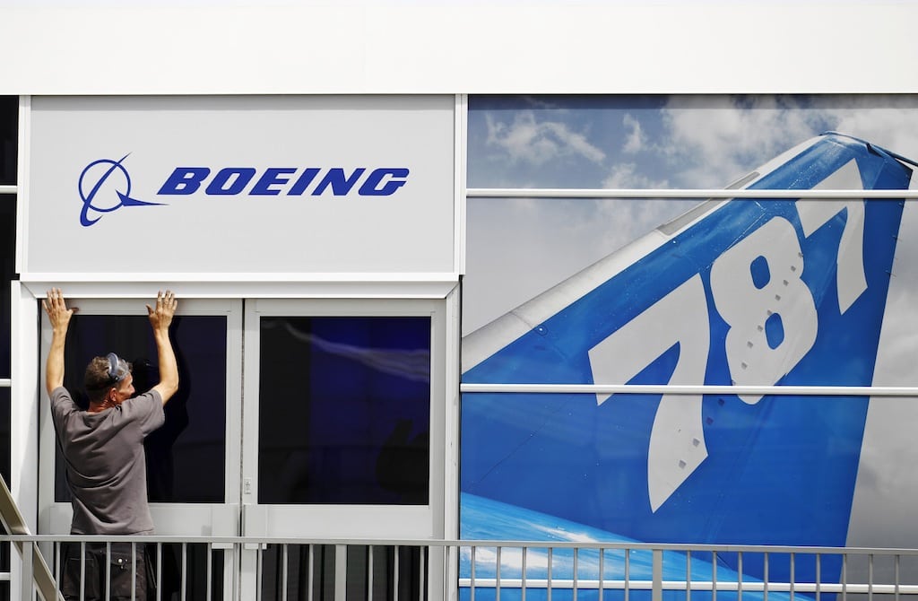 A worker prepares the Boeing chalet ahead of the Farnborough Airshow 2012 in southern England in this July 8, 2012, file photo. 