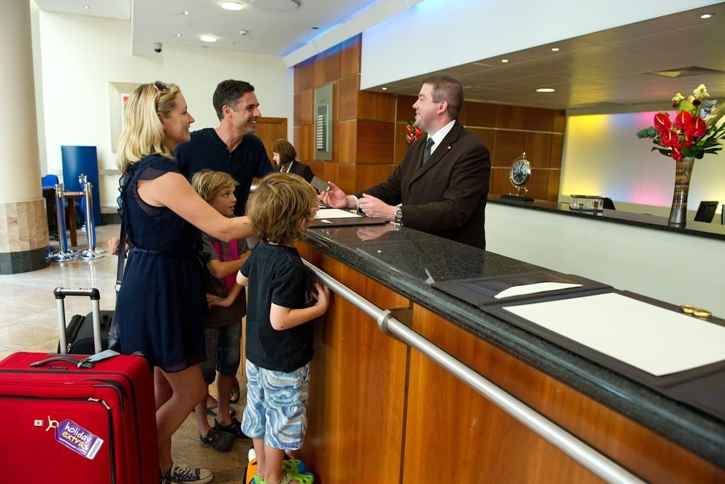 A family checks into their hotel on vacation. 