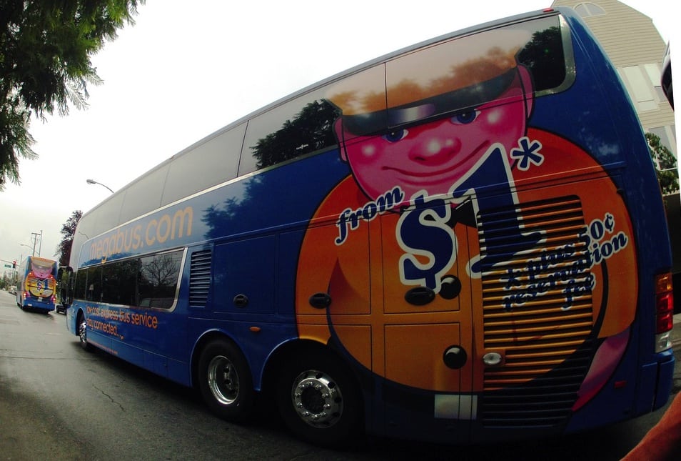 A Megabus with its advertising promising a $1 ride for only $1.50. 