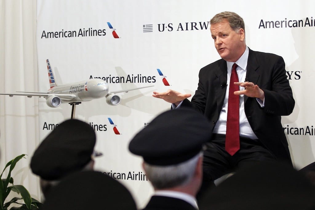 US Airways CEO Doug Parker announces the planned merger of AMR Corp, the parent of American Airlines, with US Airways, as members of the Allied Pilots Association and US Airways Pilots Association listen during a news conference at Dallas-Ft Worth International Airport February 14, 2013. 