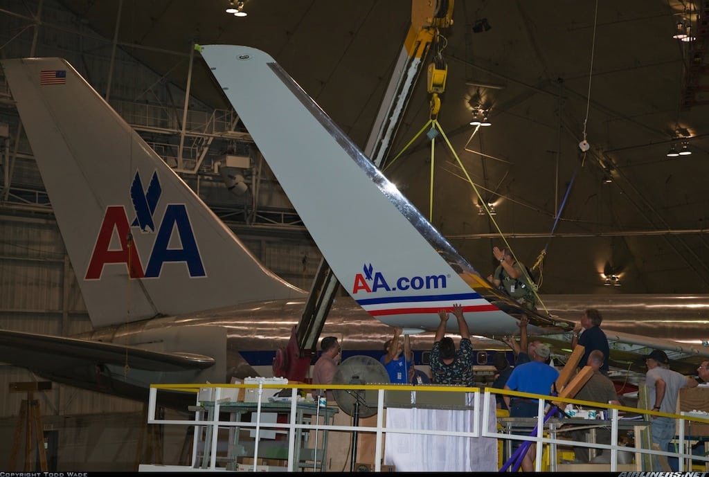 American Airlines and US Airways workers will have to harmonize certain contracts, and that is where some of the heavy lifting comes in. American Airlines workers (pictured) install fuel-efficient winglets.  