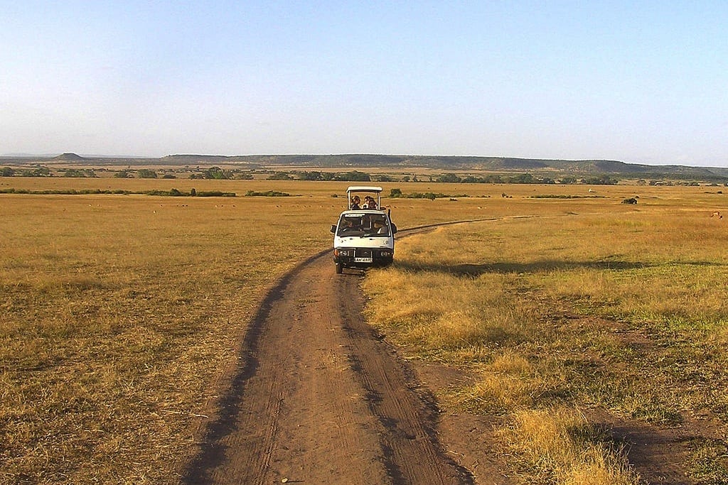 A safari car travels through Kenya. 