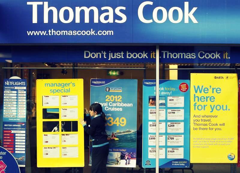 A worker changes the window display of Thomas Cook in Loughborough, central England December 14, 2011.
