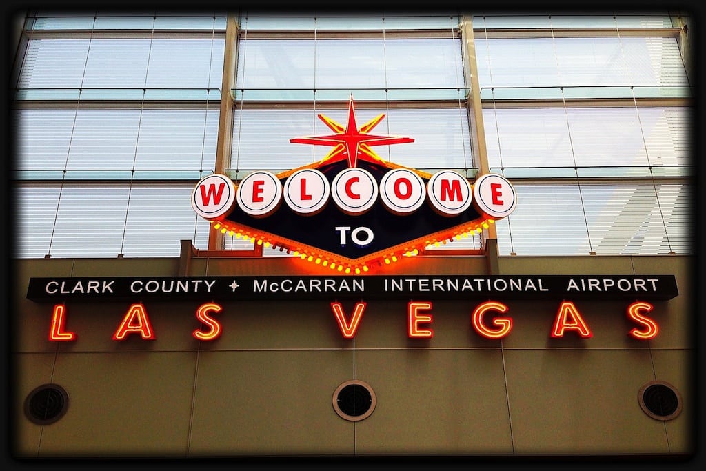 A tourist snaps a picture of the arrival sign at McCarran International Airport. 