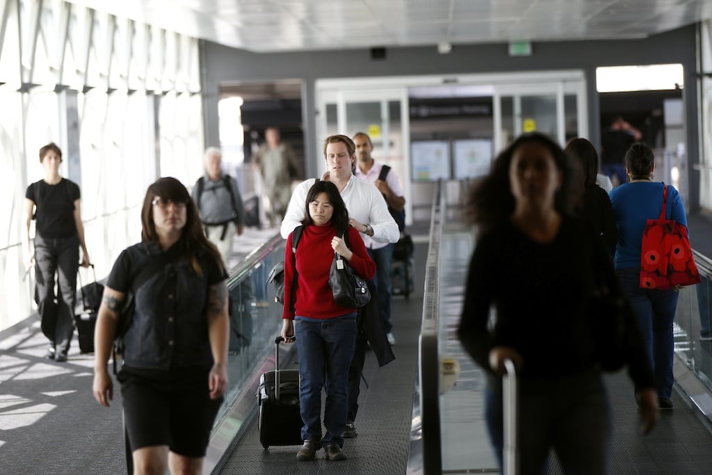 Airline passengers head to a flight at San Francisco International Airport. 