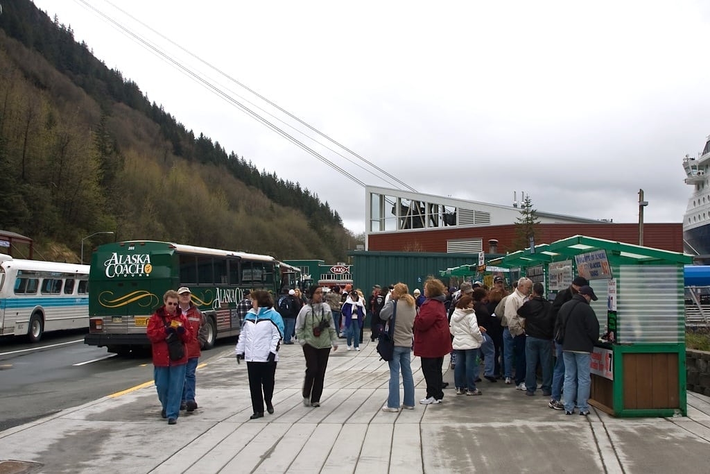 Visitors at tour-selling kiosks in Juneau's port. 