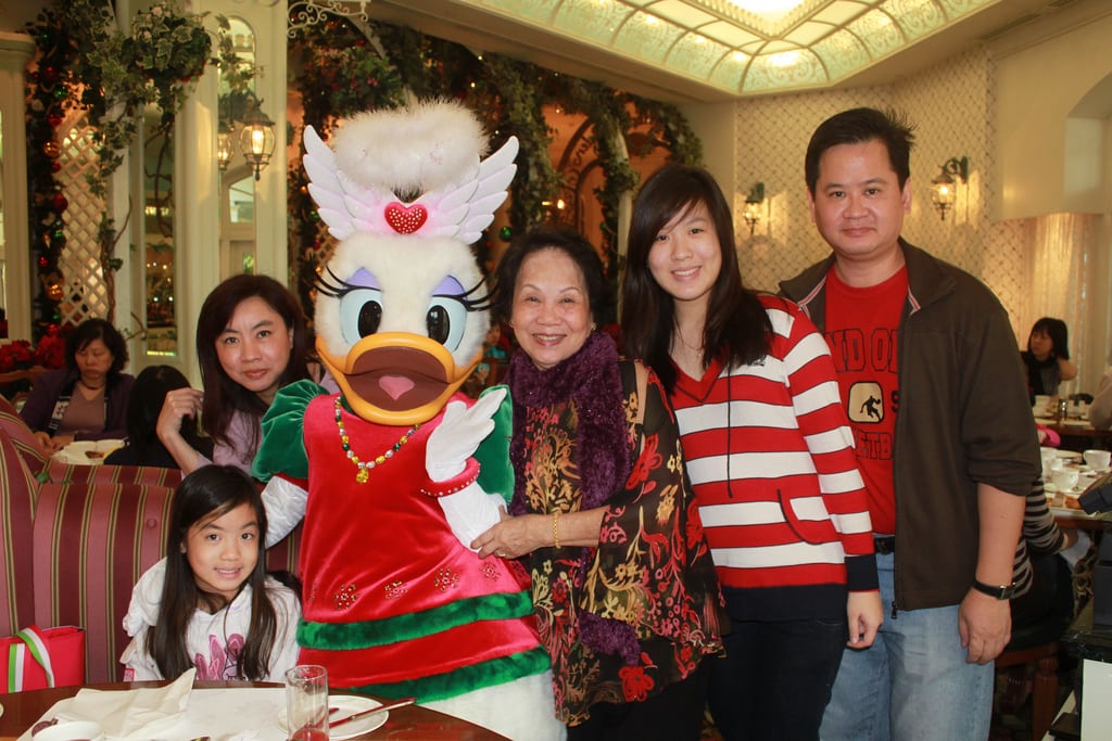 A family poses with Disney's Daisy Duck at breakfast at the Disneyland Resort in Hong Kong. 