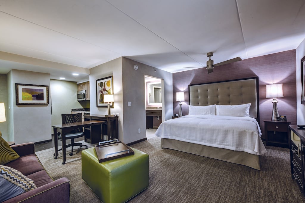 The renovated guest room features a lighter color scheme, less wood furniture, and a larger media center. 
