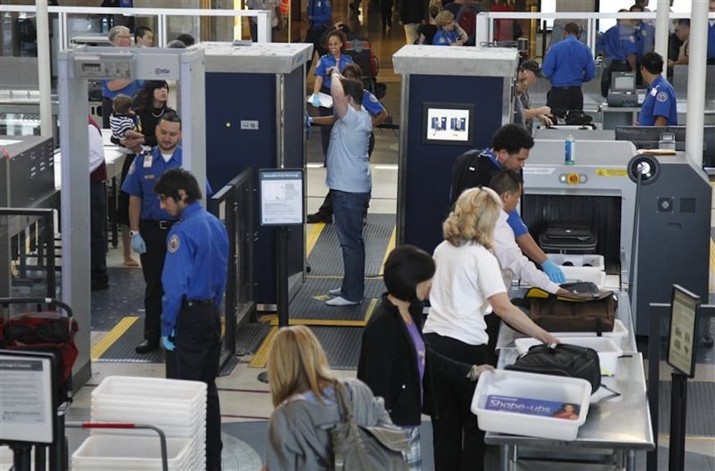 A man is screened with a backscatter x-ray machine as travellers go through a TSA security checkpoint in terminal 4 at LAX, Los Angeles International Airport, in Los Angeles May 2, 2011. 