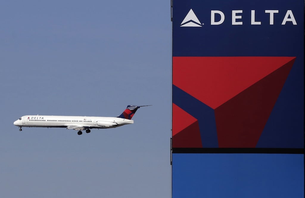 A Delta Air Lines jet flies past the company's billboard at Citi Field, in New York, on April 6, 2013.  