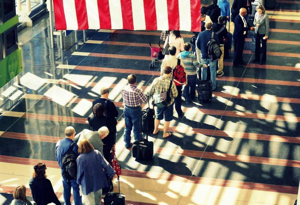 A long line of passengers wait to enter the security checkpoint before boarding their aircraft at Reagan National Airport in Washington, April 25, 2013. 