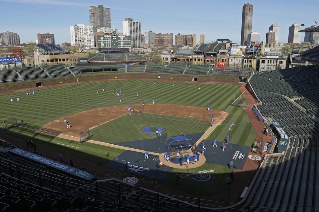 In this April 4, 2012 file photo, Chicago Cubs players work out at Wrigley Field in Chicago, the day before their home-opener baseball game. 