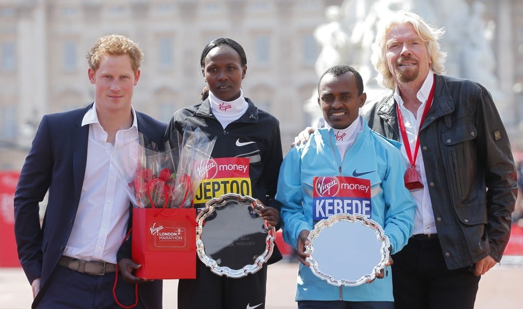Britain's Prince Harry (L) and Richard Branson (R) the CEO of Virgin pose on the podium with London Marathon winners Tsegaye Kebede of Ethiopia (2nd R) and Priscah Jeptoo (2nd L) of Kenya on the Mall in central London. 