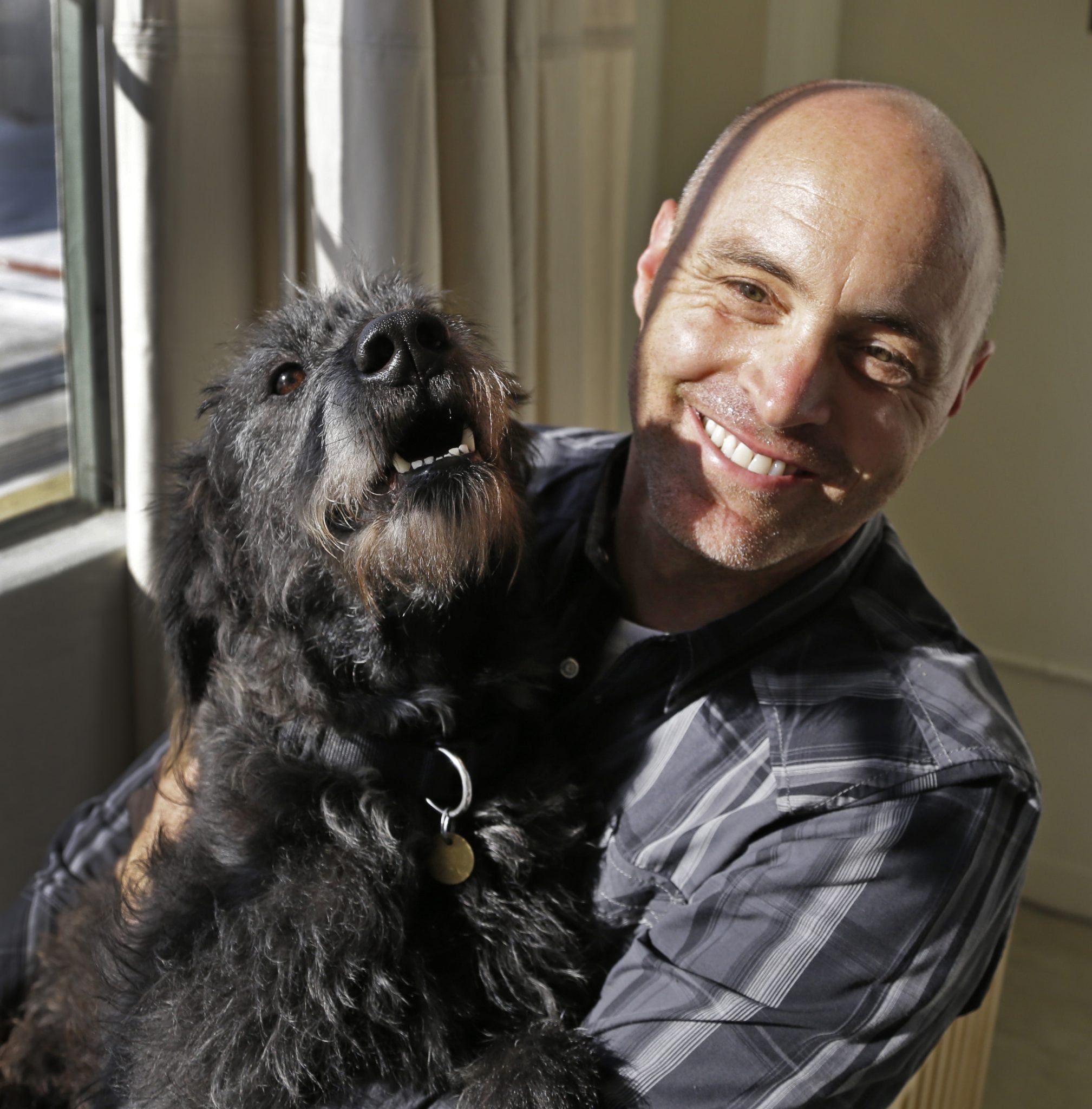Martin Sprouse with 'Grady,' an Airedale Terrier-Irish Wolfhound mix, Thursday, April 18, 2013, in Oakland, Calif. 