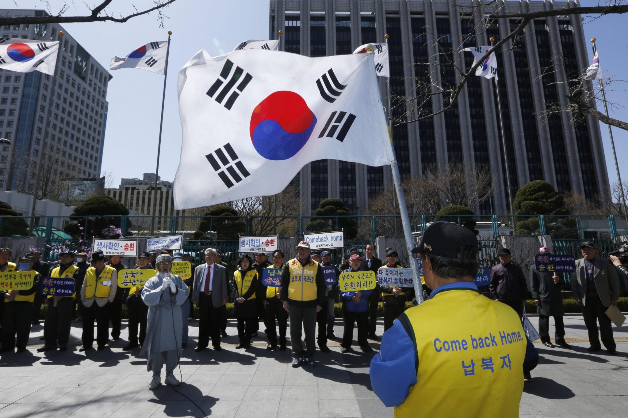 South Korean members of the Abductees Family Association with their national flags hold an anti-North Korea rally in Seoul, South Korea, Sunday, April 14, 2013. 