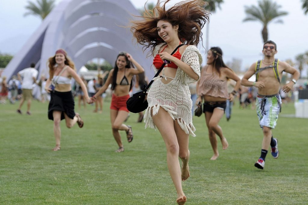 This April 13, 2012 file photo shows festivalgoers running toward the main stage to catch the beginning of Kendrick Lamar's set during the first weekend of the 2012 Coachella Valley Music and Arts Festival in Indio, Calif. 