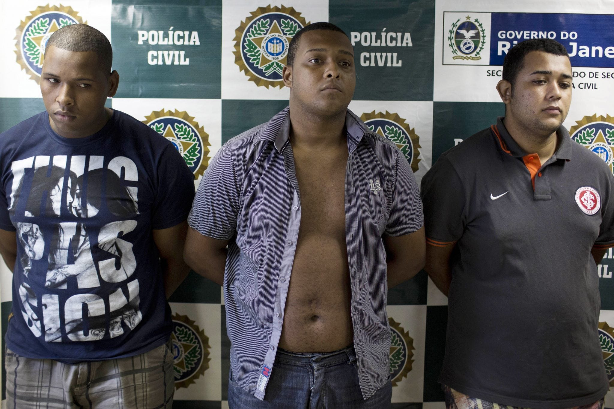 Suspects are presented to the press at the Special Police Unit for Tourism Support (DEAT) after being arrested for allegedly attacking tourists in Rio. 