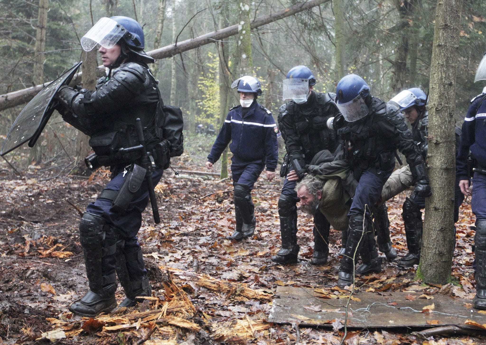 This Nov. 24, 2012 file photo shows French gendarmes detaining a protester during an evacuation operation on land that will become the new airport in Notre-Dame-des-Landes, western France. 