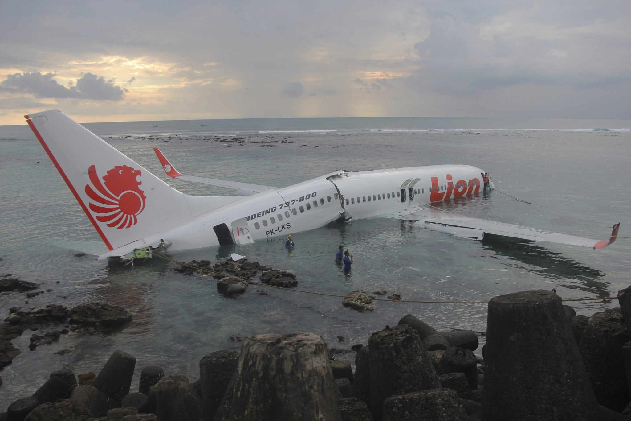 A handout picture provided by the Indonesian police, a Lion Air plane is seen in the water after missed the runway in Denpasar, Bali