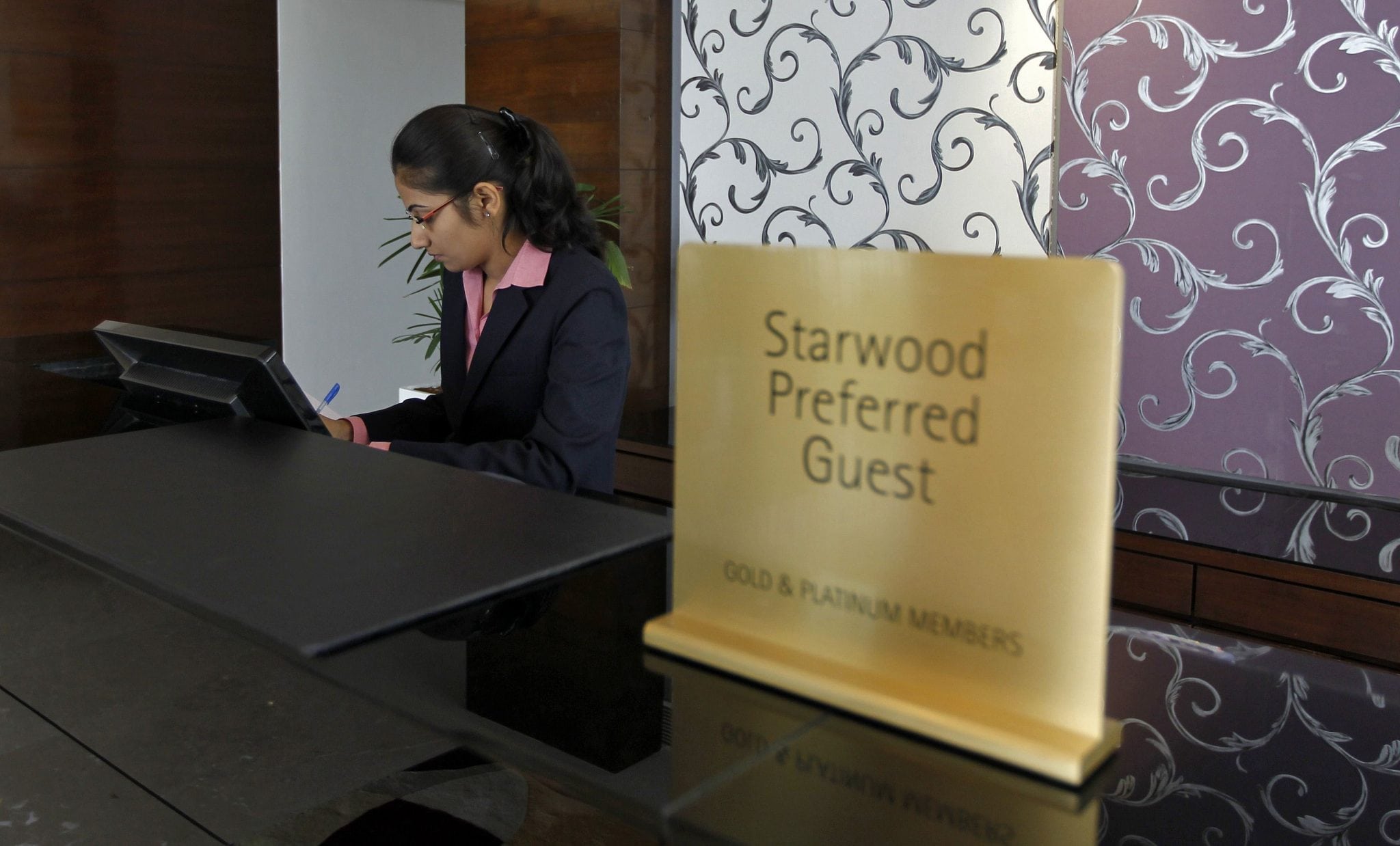 An employee works at the reception of the Four Points hotel in the western Indian city of Ahmedabad. 