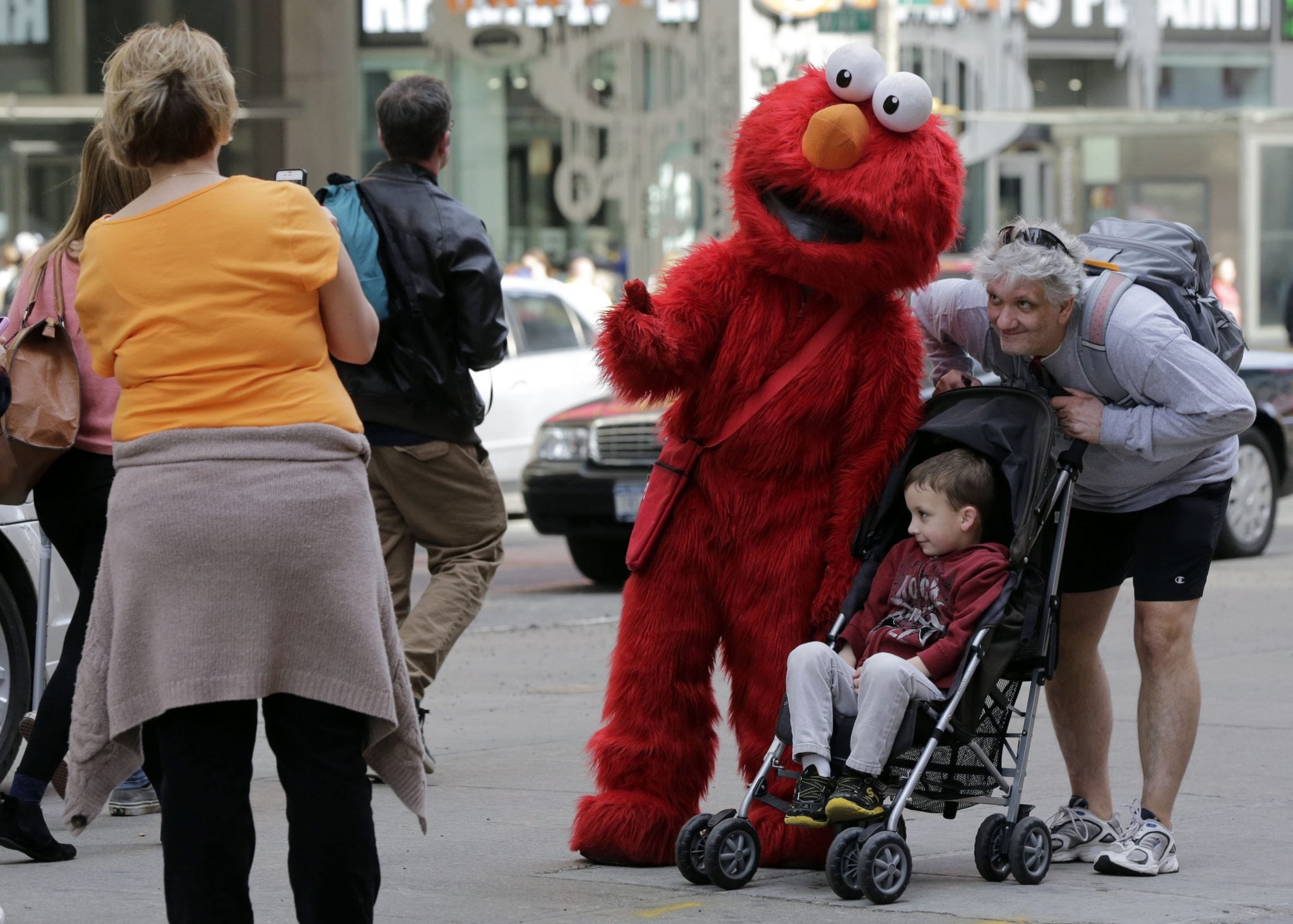 An Elmo character poses for photos in New York's Times Square, Tuesday, April 9, 2013. 