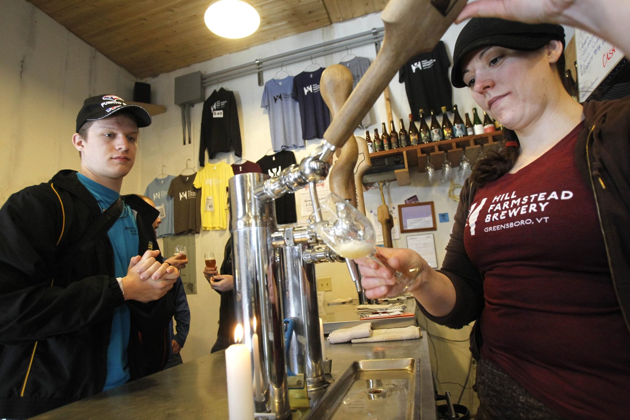 In this Wednesday, April 3, 2013 photo, Jordan Aders from Indiana, left, watches as Kerrie Montgomery draws a beer tasting at Hill Farmstead Brewery in Greensboro, Vt. Vermonters are buzzing about beer, and with good reason. 