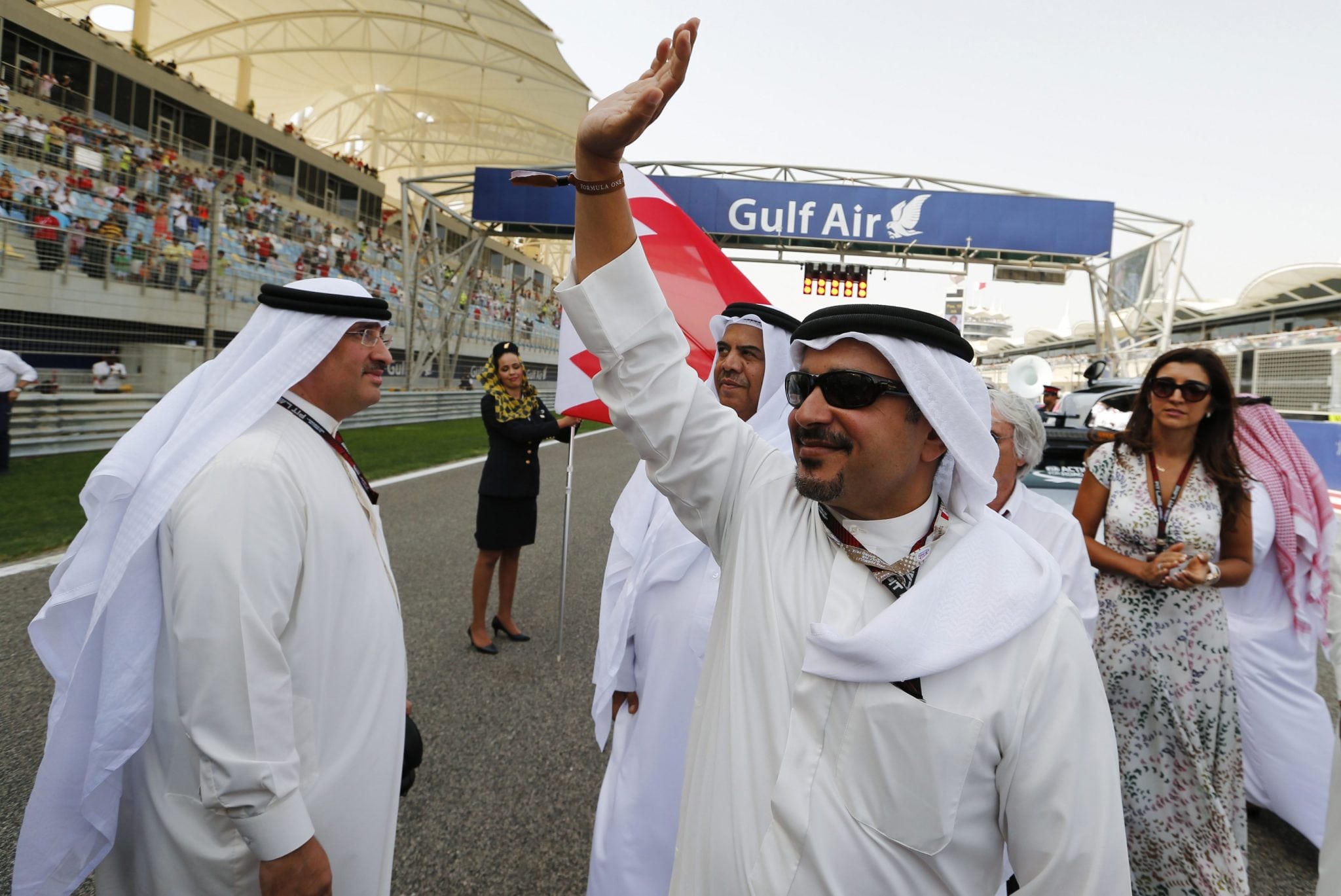 Bahrain's Crown Prince Salman bin Hamad al-Khalifa waves to spectators as he arrives before the Bahrain F1 Grand Prix at the Sakhir circuit, south of Manama April 21, 2013. 