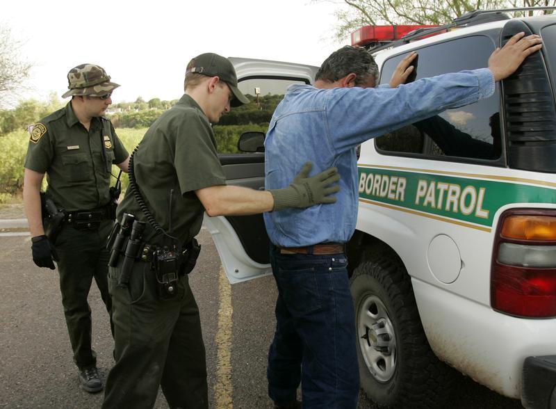 Border Patrol Agent searches undocumented immigrant caught coming into Laredo. 