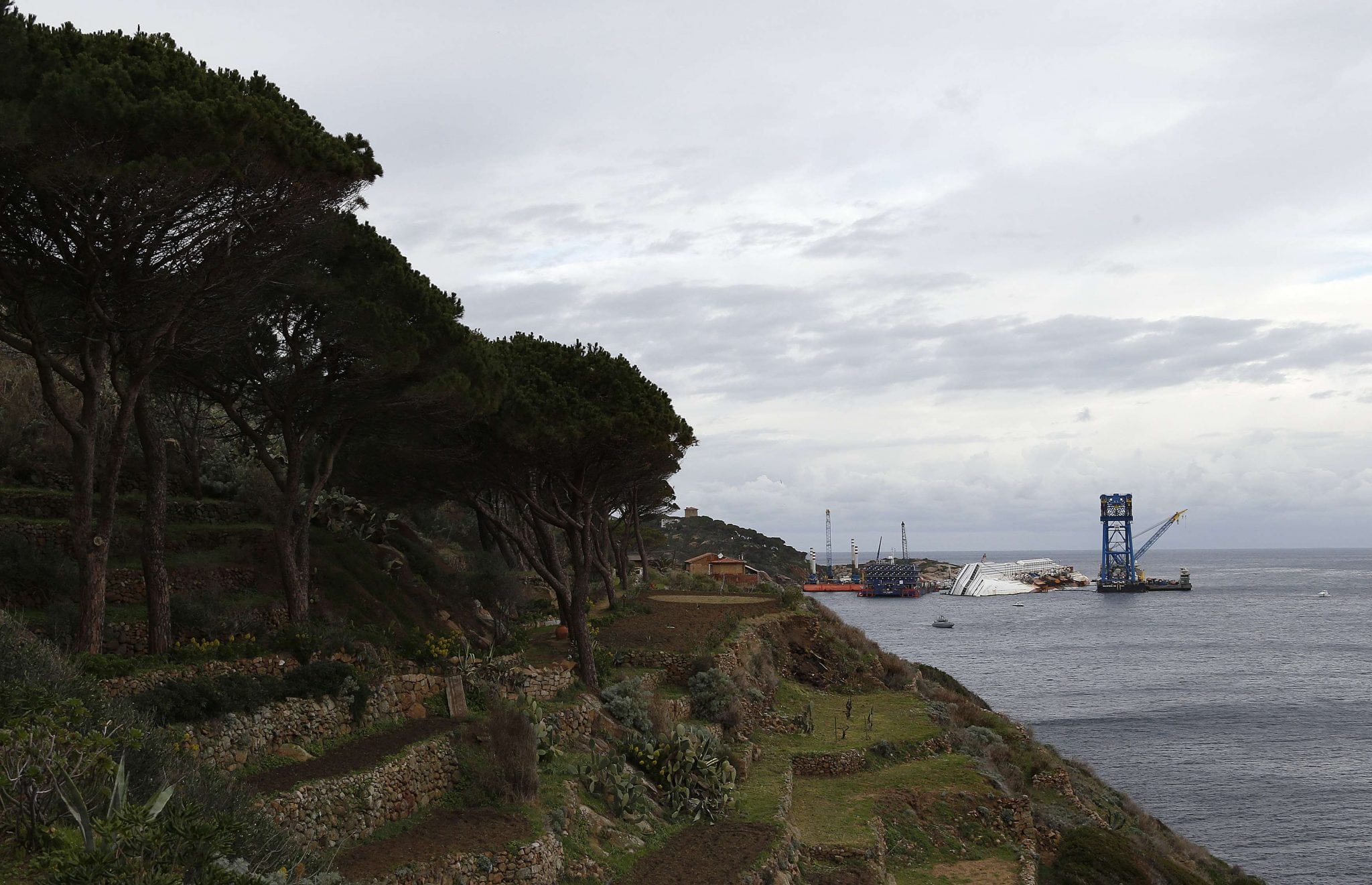 The capsized cruise liner Costa Concordia lies surrounded by cranes outside Giglio harbour. 