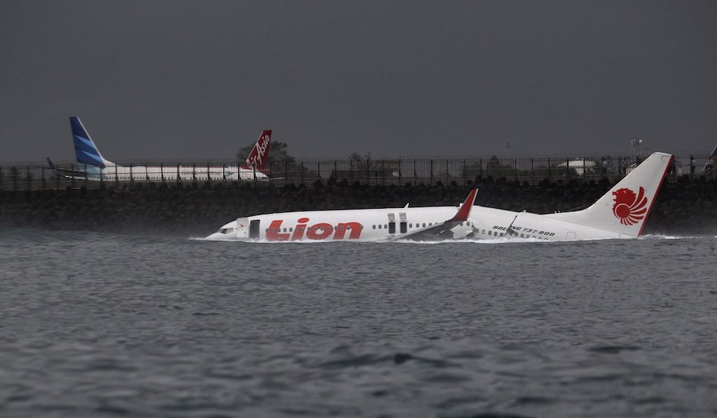 The body of a Lion Air plane is seen in the water after it missed the runway in Denpasar, Bali April 13, 2013. Reuters/Stringer