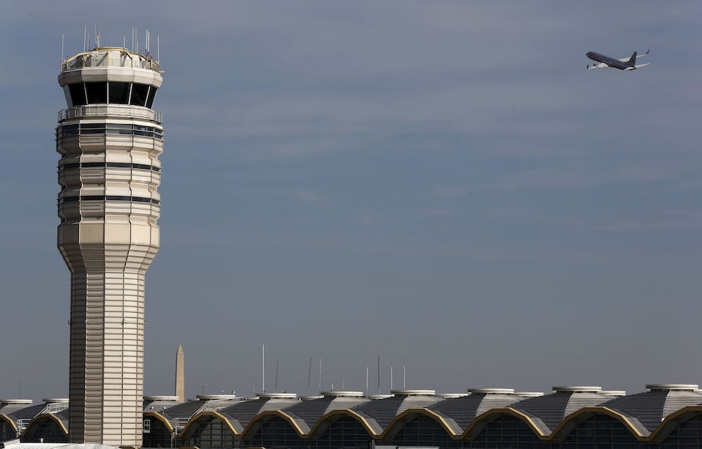 A jet departs Washington's Reagan National Airport next to the control tower outside Washington, in this February 25, 2013 file photo. 