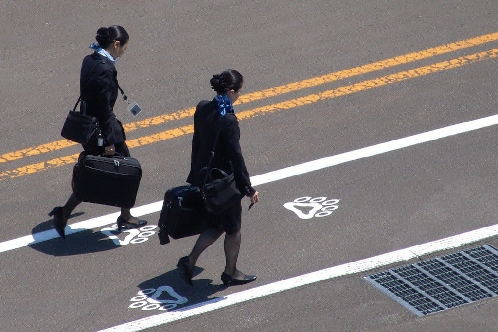 Flight attendants walk near Sapporo Okadama Airport in Japan. 