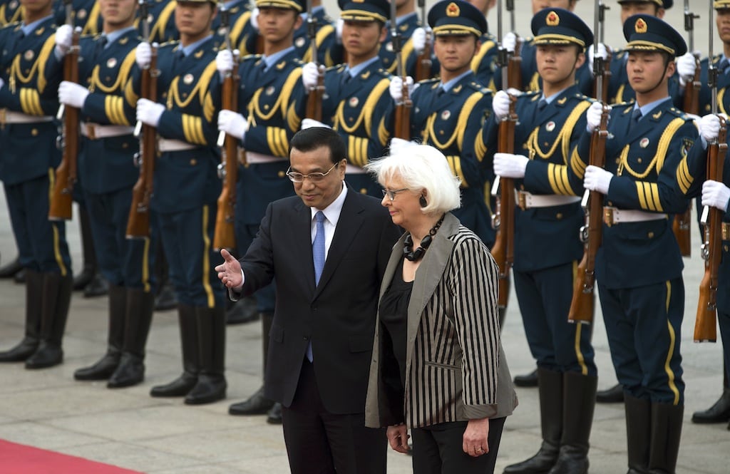 Iceland's Prime Minister Johanna Sigurdardottir, right, is shown the way by Chinese Premier Li Keqiang after inspecting a guard of honor during a welcome ceremony outside the Great Hall of the People in Beijing Monday, April 15, 2013. 