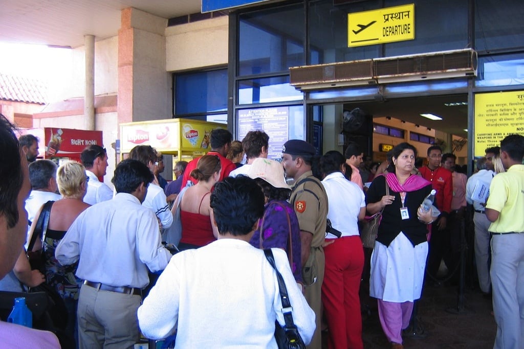 British, Indian, and Israeli travelers line up at the boarding gate in Goa International Airport. 