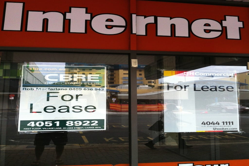 A man takes a picture of a cyber cafe that went out of business in Cairns, Australia. 