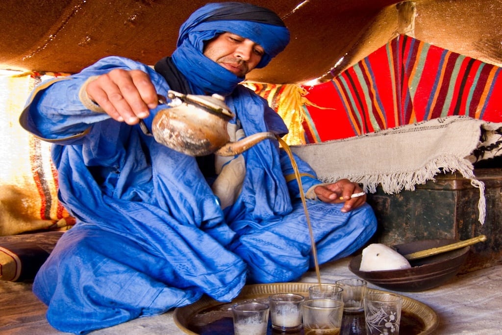 A Tuareg man pours tea for tourists in southern Morocco. 