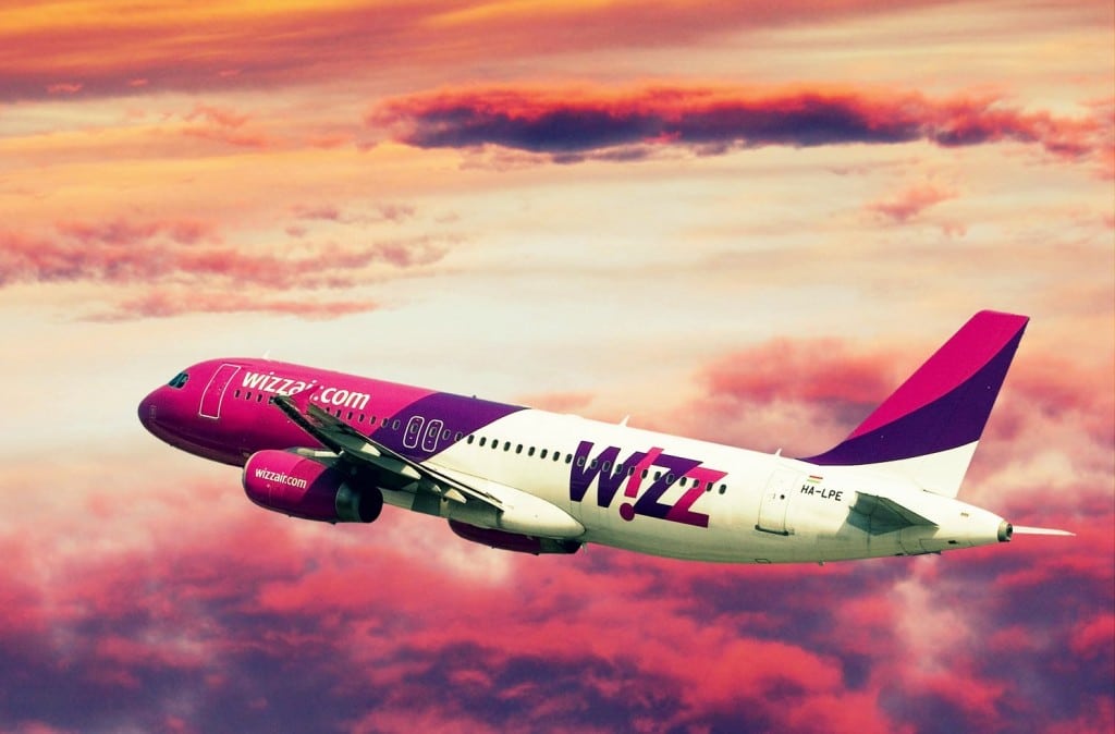 Wizz Airlines aircraft disappears in the purple sky. 