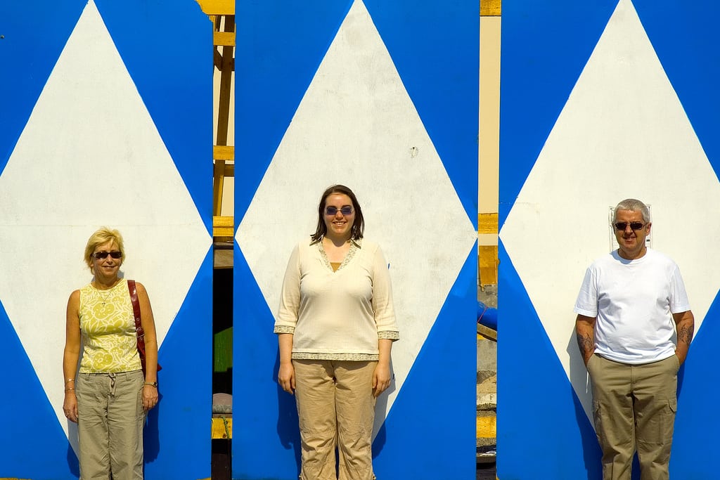 A family of tourists poses for a photo in front of a building site in Dubai. 