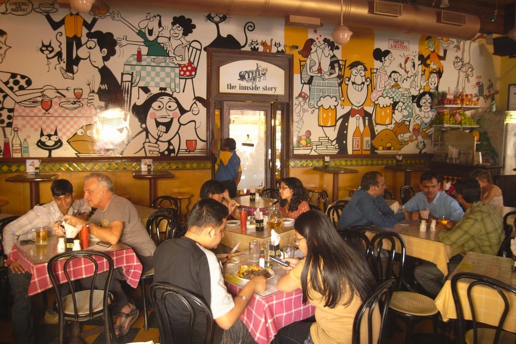 The Parsi cafes in Mumbai, including Cafe Mondegar, shown in this 2009 photo, are each "crumbling in their own special way," says the author.  