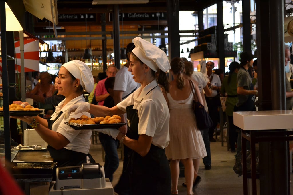 Waitresses fill their trays at a tapas bar in Madrid. 