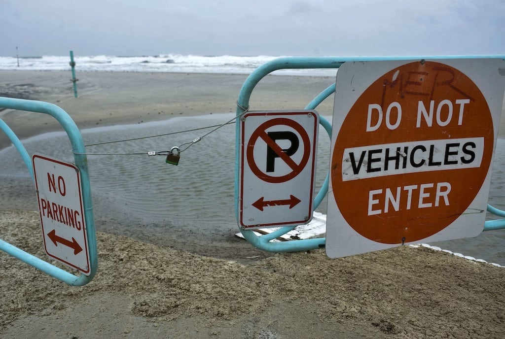 A padlock holds an entrance gate closed to block vehicle access to the beach in Daytona Beach, Florida, as Hurricane Sandy passes offshore October 26, 2012.  