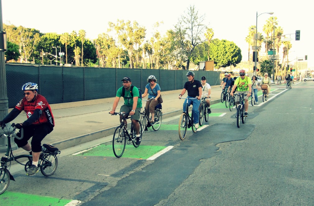 A brewery tour takes visitors on a bike ride down the Spring Street bike lane in Los Angeles. 