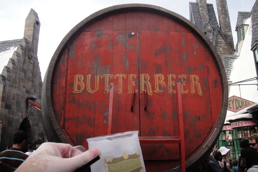 A tourist toasts to the giant Butterbeer cart keg in the Wizarding World of Harry Potter theme park. 