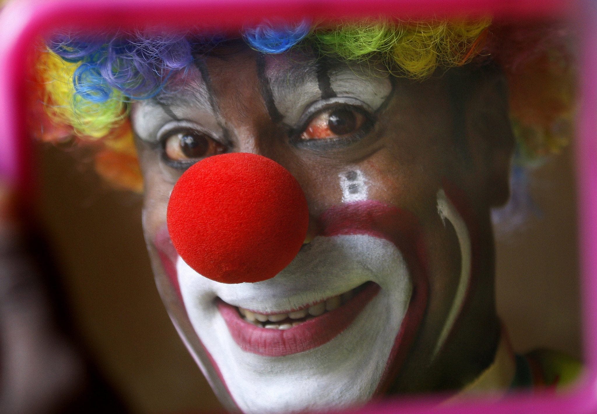 In this April 11, 2013 photo, Biju Nair, principal clown at Rambo Circus, looks at a mirror before a performance on the outskirts of Mumbai, India. 