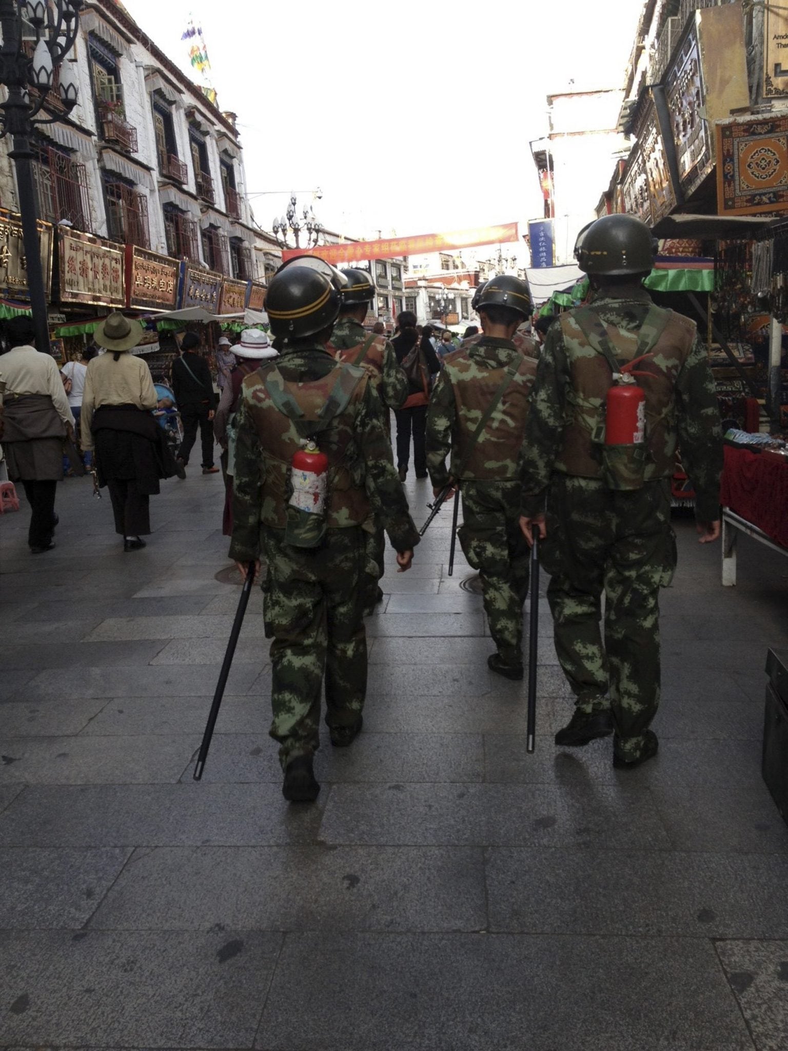 Undated handout photo of paramilitary policemen, equipped with fire extinguishers, patrol on a street of Lhasa. 
